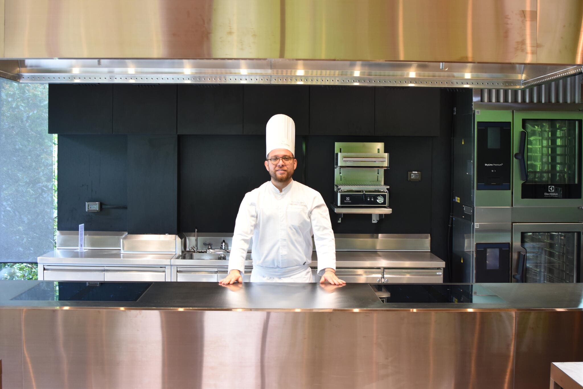 Chef standing in modern professional kitchen at École Ducasse Bangkok Studio equipped with Electrolux Professional solutions