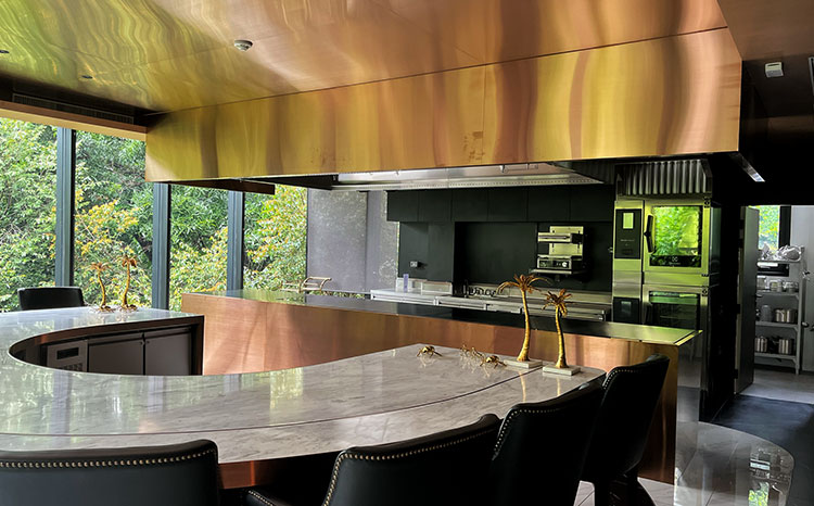 Elegant dining counter integrated with Electrolux Professional kitchen at École Ducasse Bangkok Studio