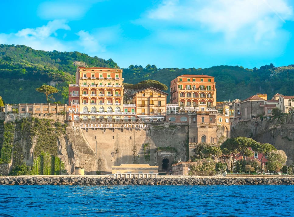 Panorama picture with a large hotel on a cliff on the sea