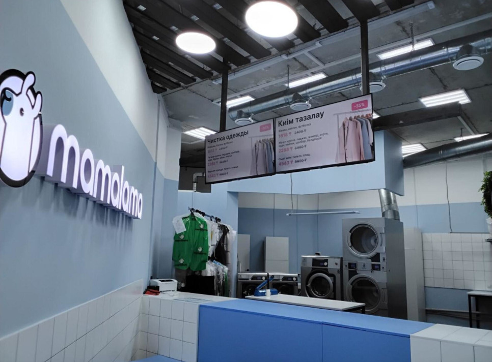 Small laundry shop with light blue walls and a lama as a logo