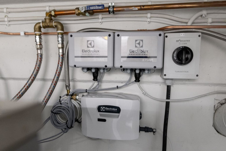 Electrolux Professional laundry dosing system installed on facility wall for detergent control
