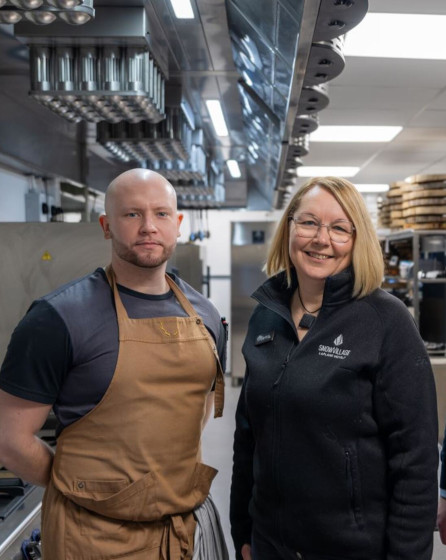 Chef and partner standing in modern hotel resort kitchen equipped with Electrolux Professional equipment