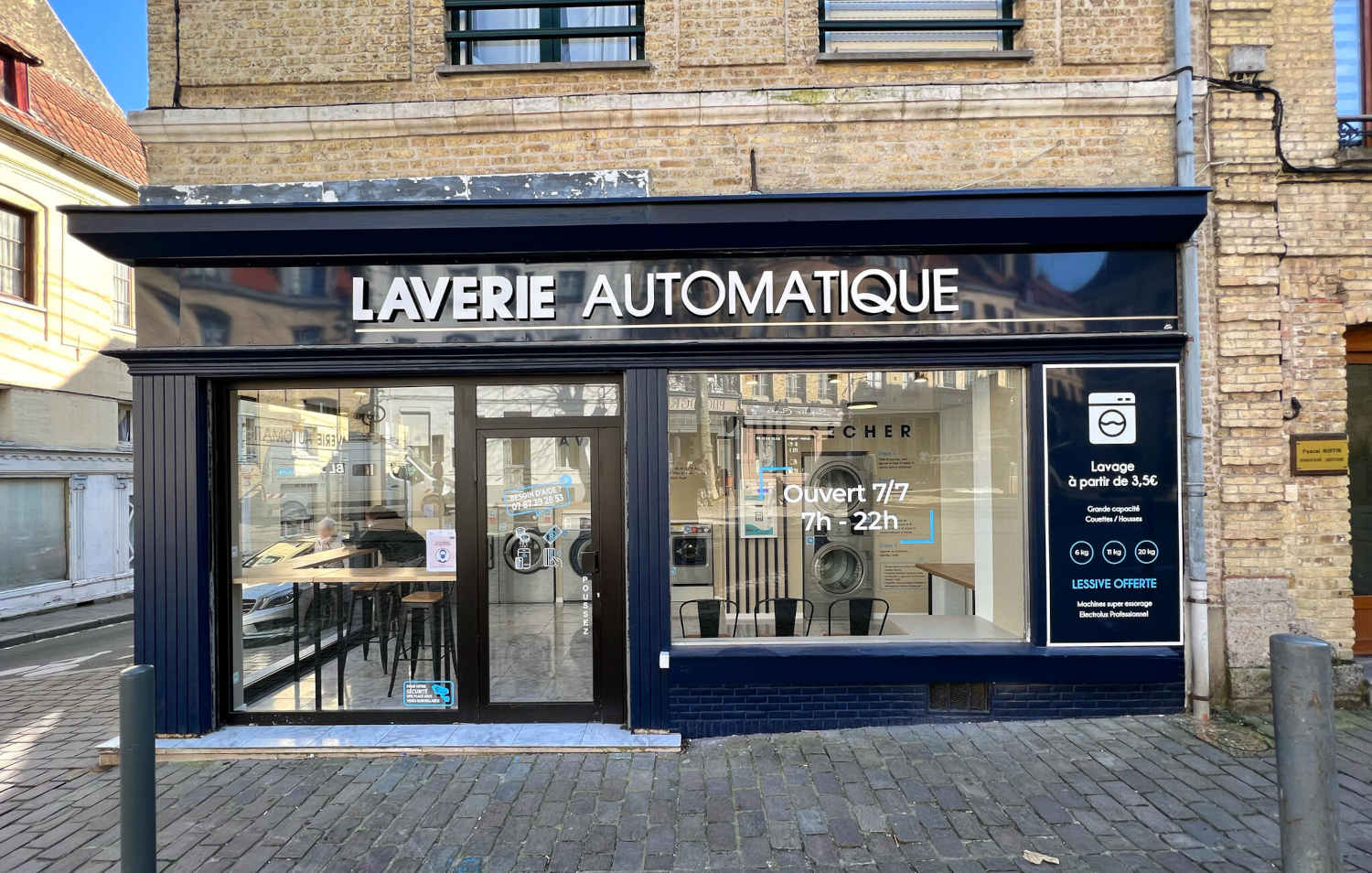 Exterior view of St Omer Laundromat with signage “Laverie Automatique” and Electrolux Professional laundry facility inside
